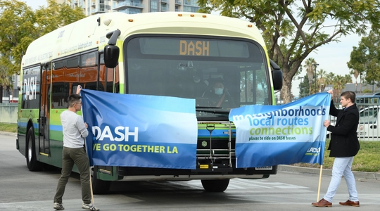 NoHo DASH Bus breaking the ribbon