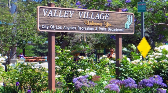 Sign saying "Valley Villiage" at park 