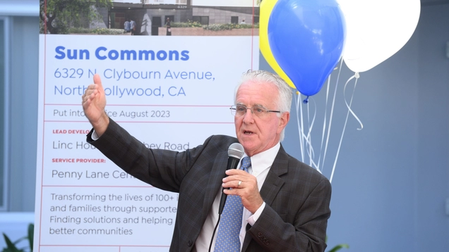 Council President Krekorian, surrounded by balloons, addresses crowd at opening of Sun Commons.