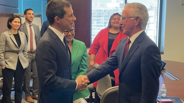 Secretary of Transportation Pete Buttigieg shakes hands with Council President Krekorian as Mayor Bass and other Councilmembers look on. 